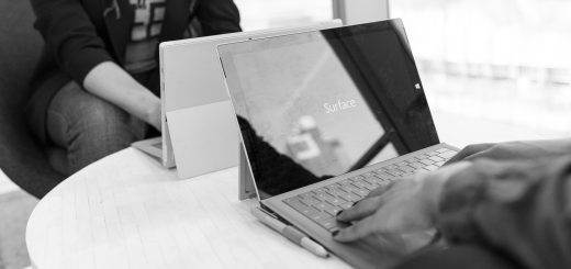 Two people using a laptop on a table