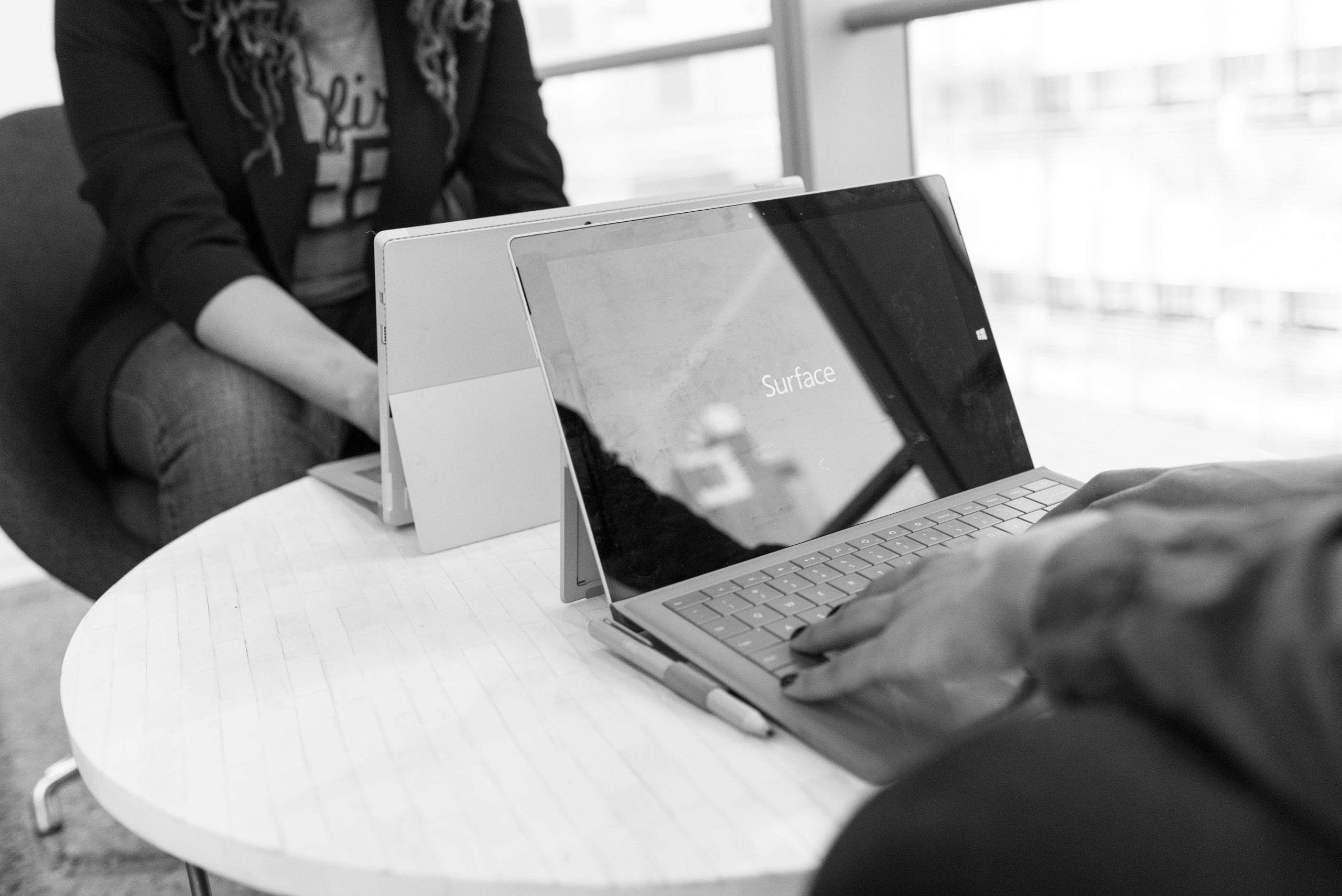 Two people using a laptop on a table